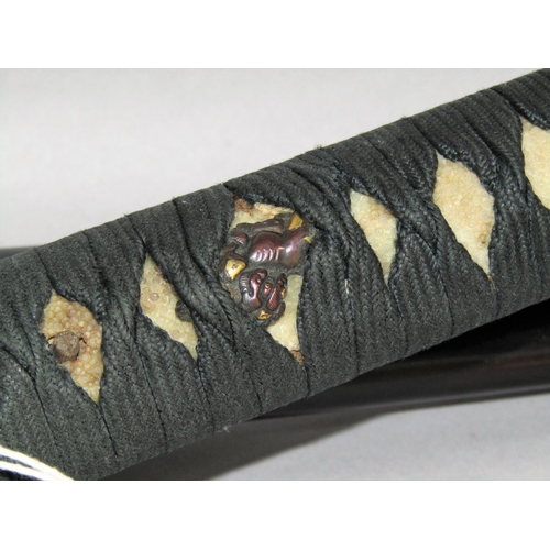 1485A - A Japanese sword with black lacquered scabbard with paperwork