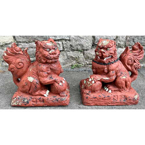 2090 - A pair of composition stone temple lions/dogs of fo with painted finish, 38cm high approx