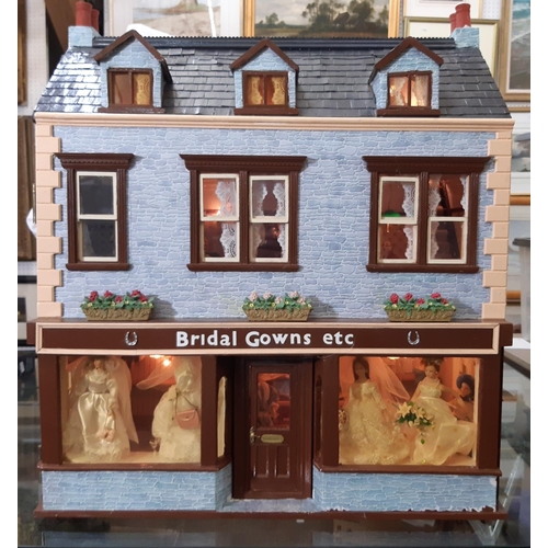 253 - 'Bridal Gowns etc'- an impressive and finely detailed period style dolls house shop comprising 3 sto... 