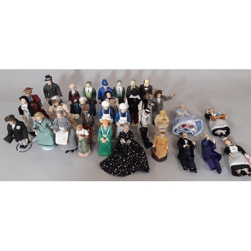 256 - A collection of 30 dolls house period character figures including ladies, gentlemen, staff, a police... 