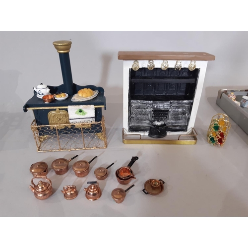 258 - A large collection of dolls house furnishings comprising kitchen related furniture, foods and utensi... 