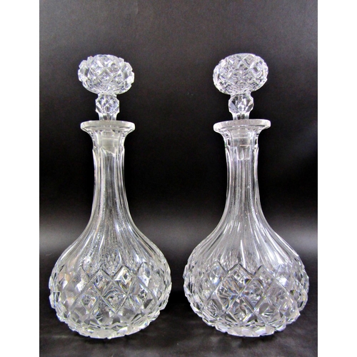 1172 - A pair of rounded cut glass decanters and a third similar, with a single hallmarked silver Madeira l... 