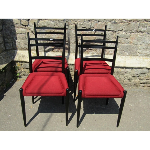 2153 - A set of six G-Plan dining chairs with ebonised frames and red upholstered seats