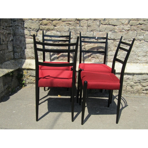 2153 - A set of six G-Plan dining chairs with ebonised frames and red upholstered seats