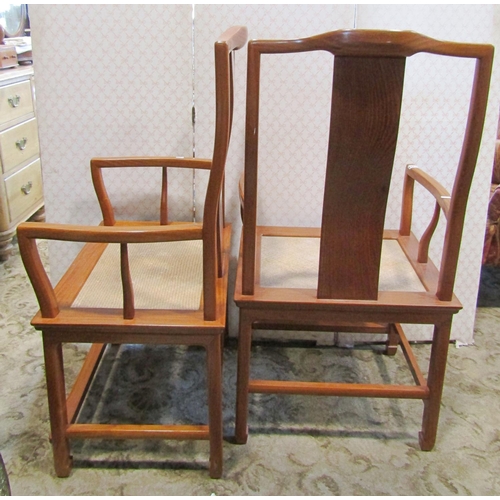 2176 - A pair of Chinese hardwood elbow chairs with shaped splats, woven seats, raised on square cut suppor... 