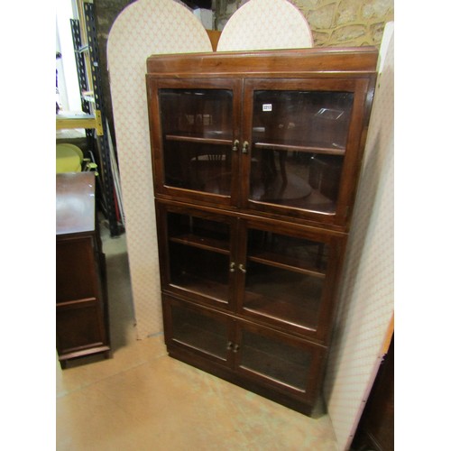 2183 - A three section mahogany bookcase enclosed by three pairs of glazed panelled doors, with brass fitti... 