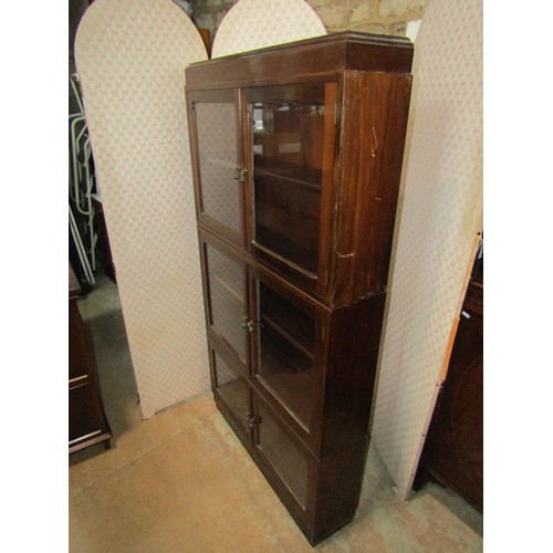 2183 - A three section mahogany bookcase enclosed by three pairs of glazed panelled doors, with brass fitti... 