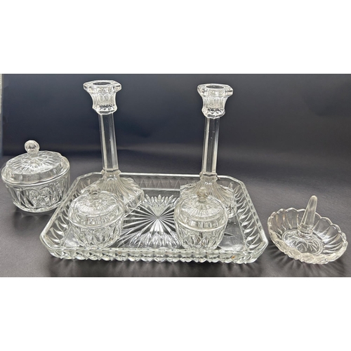 An early 20th century glass dressing table set of a pair of candlesticks,  three jars, a ring stand o