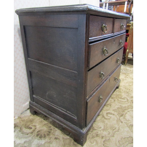 2210 - An old English countrymade chest of three long and two short drawers in mixed woods, raised on brack... 