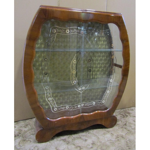 2302 - 1950s walnut veneered display cabinet, with shaped outline and glazed panelled sliding doors