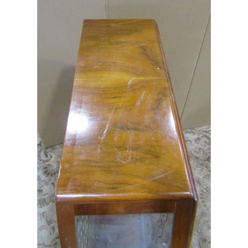 2302 - 1950s walnut veneered display cabinet, with shaped outline and glazed panelled sliding doors