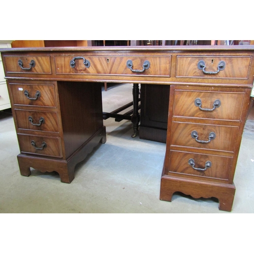 2316 - A Georgian style pedestal writing desk of nine drawers with inset leather top, 125cm wide