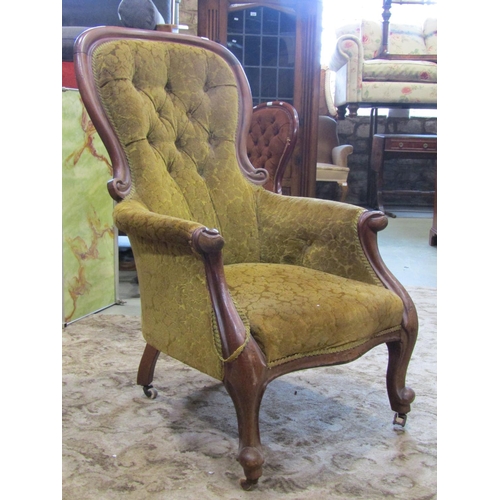 2343 - A Victorian mahogany drawing room chair with partial show wood frame, buttoned back finish on cabrio... 