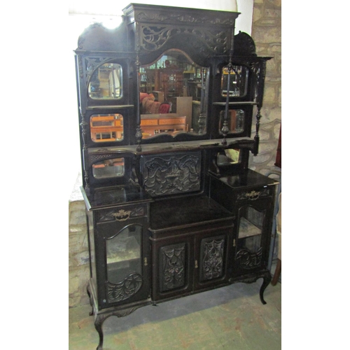 2347 - An Edwardian ebonised chiffonier of full height, the lower section enclosed by a series of doors and... 