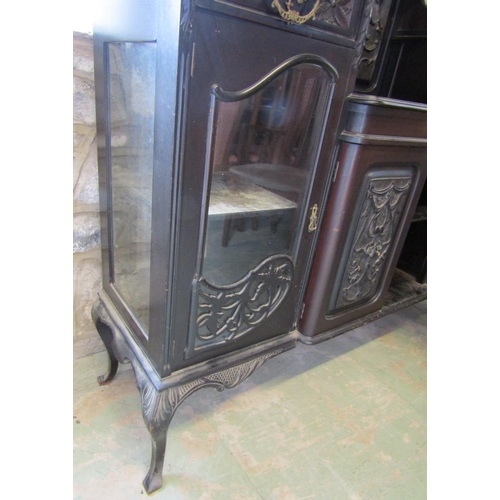 2347 - An Edwardian ebonised chiffonier of full height, the lower section enclosed by a series of doors and... 