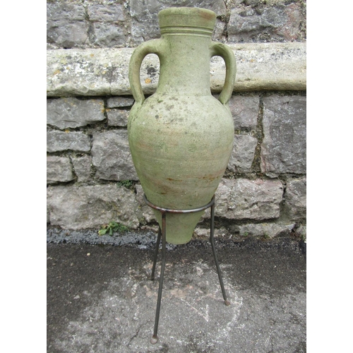 2067 - A small Mediterranean weathered buff coloured terracotta amphora, with moulded loop handles, raised ... 