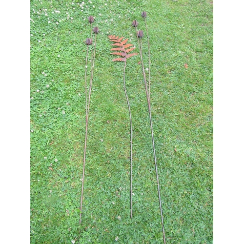 2068 - A pair of decorative ornamental heavy gauge steel garden teasel border stakes, together with a fern ... 