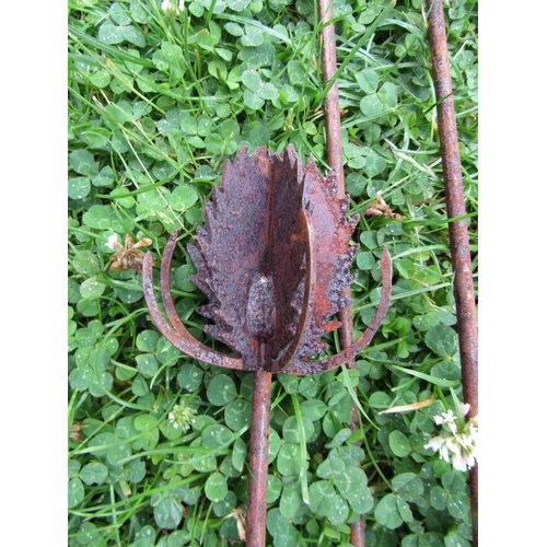 2068 - A pair of decorative ornamental heavy gauge steel garden teasel border stakes, together with a fern ... 