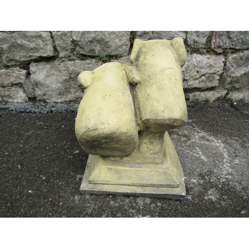 2071 - A buff coloured composition stone study of greyhound heads, of stepped form, set on a rectangular pl... 