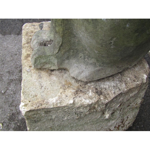 2083 - A weathered garden ornament in the form of a seated cat, raised on loose stone block pedestal, 78cm ... 