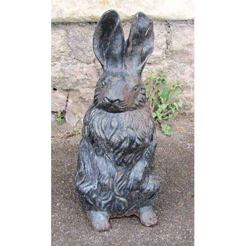 2091 - A vintage cast iron novelty garden or interior ornament in the form of a seated rabbit, 43cm high