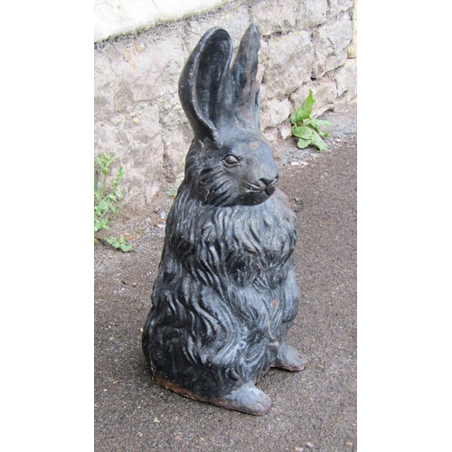 2091 - A vintage cast iron novelty garden or interior ornament in the form of a seated rabbit, 43cm high