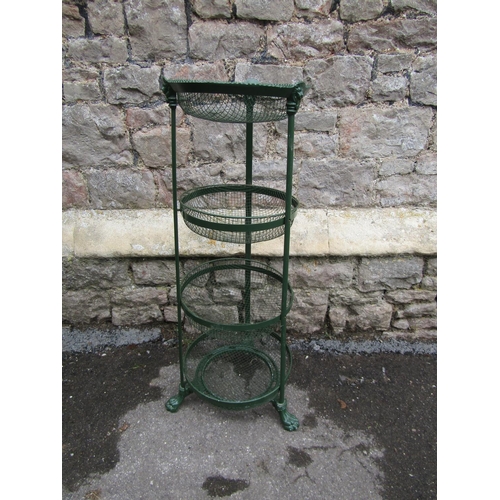 2099 - A green painted cast metal vegetable stand on four graduated removeable circular basket tiers with s... 