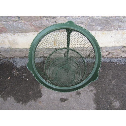 2099 - A green painted cast metal vegetable stand on four graduated removeable circular basket tiers with s... 