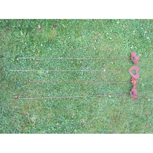 2106 - Four weathered steel ornamental garden border stakes comprising two poppy. sunflower and a heart sha... 