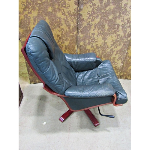 2167 - A Stressless style swivel and adjustable lounge chair and matching footstool raised on five splay pr... 