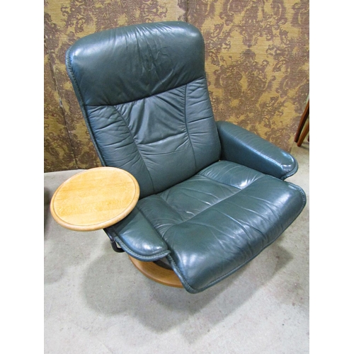 2169 - An Ekorness Stressless  swivel and adjustable lounge chair and matching stool with dark stitched sof... 