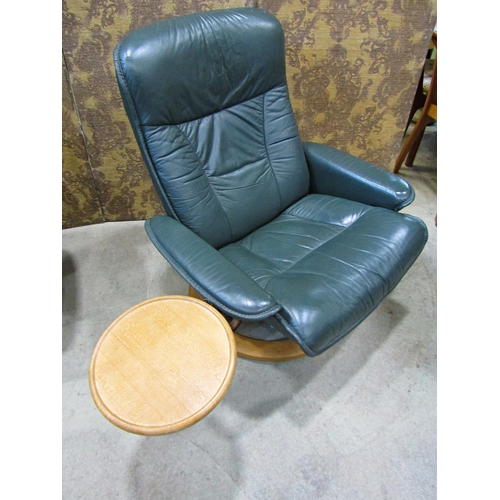 2169 - An Ekorness Stressless  swivel and adjustable lounge chair and matching stool with dark stitched sof... 