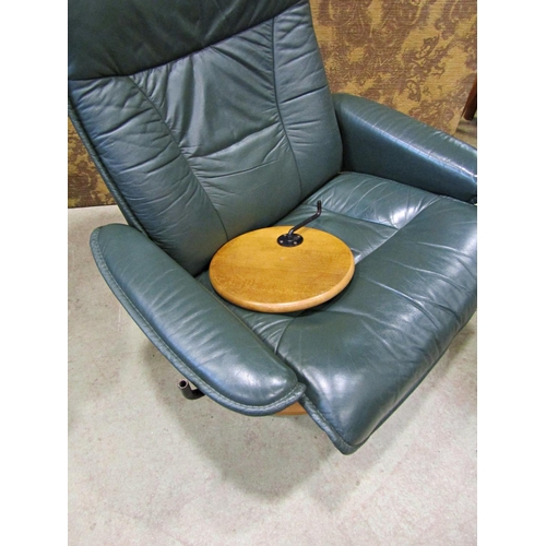 2169 - An Ekorness Stressless  swivel and adjustable lounge chair and matching stool with dark stitched sof... 