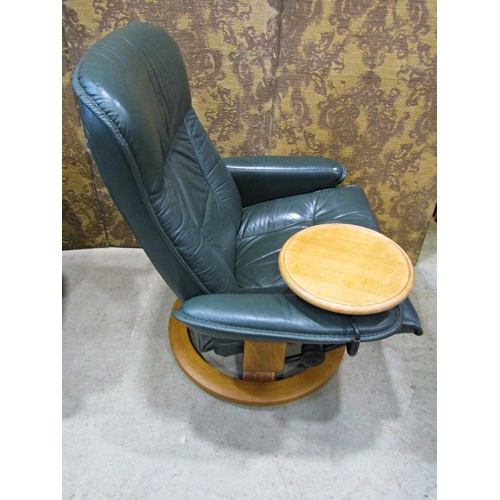 2169 - An Ekorness Stressless  swivel and adjustable lounge chair and matching stool with dark stitched sof... 