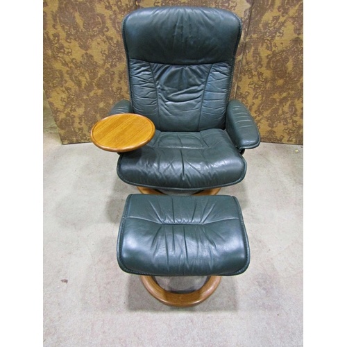 2170 - An Ekorness Stressless  swivel and adjustable lounge chair and matching stool with dark stitched sof... 