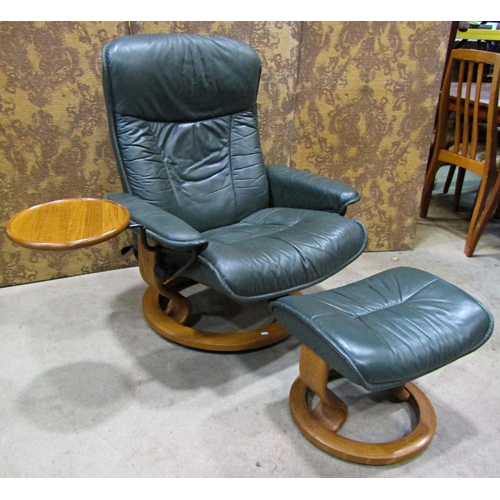 2170 - An Ekorness Stressless  swivel and adjustable lounge chair and matching stool with dark stitched sof... 