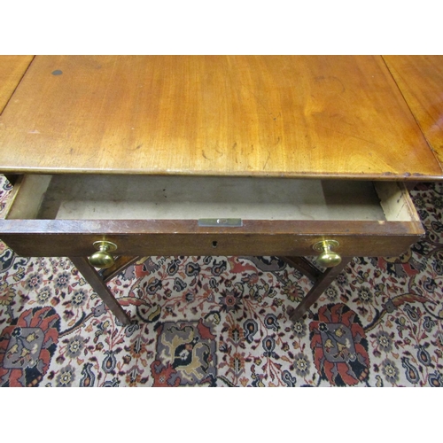 2616 - A Georgian mahogany Pembroke table enclosing a frieze drawer with four chamfered supports united by ... 