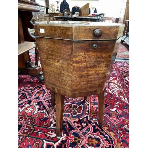 2621 - A George III mahogany cellarette, of octagonal form on square tapering legs with barrel castors, 45.... 