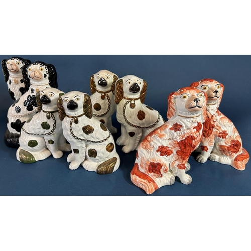 1108 - A pair of 19th century Staffordshire spaniels with abstract rust coloured patches, together with a f... 