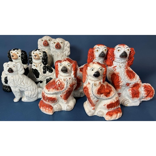 1108 - A pair of 19th century Staffordshire spaniels with abstract rust coloured patches, together with a f... 