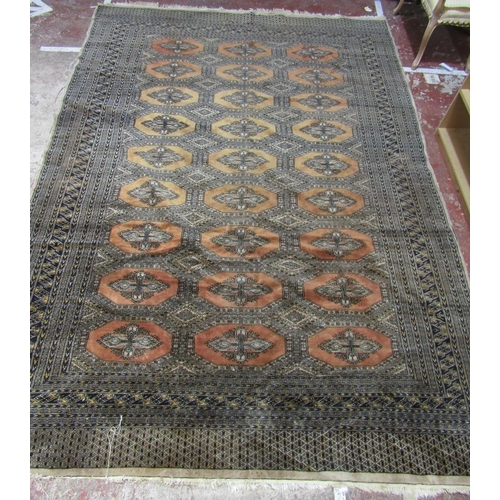 1670 - A Large Princess Bokhara Design Rug in faded burnt orange tones with an intricate dark blue border, ... 