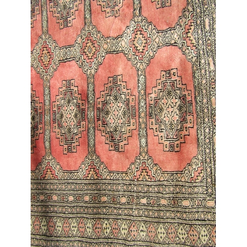 1681 - A Rose-Pink Princess Bokhara Rug with two central rows of guls and detailed borders bearing a signat... 