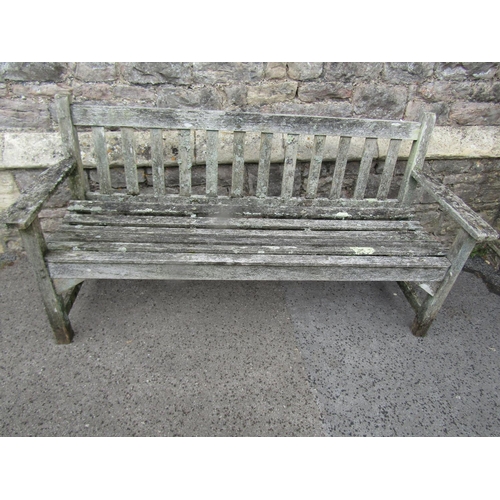 2016 - A weathered teak three seat garden bench with slatted seat and back, probably a Lister example, labe... 