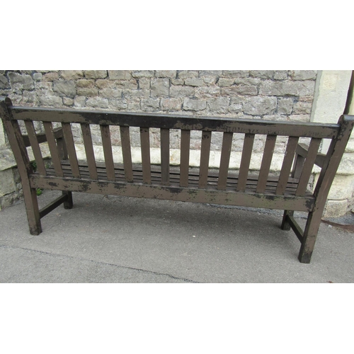 2031 - A good quality stained and weathered Gloster teak three seat garden bench with slatted seat and back... 