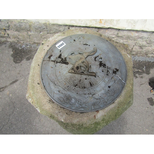 2055 - A weathered garden sundial, the circular plate with raised relief bird detail and pierced gnomon rai... 