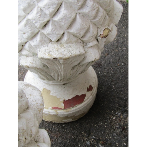 2085 - a pair of over painted and weathered decorative cast composition stone pineapple pier cap finials wi... 