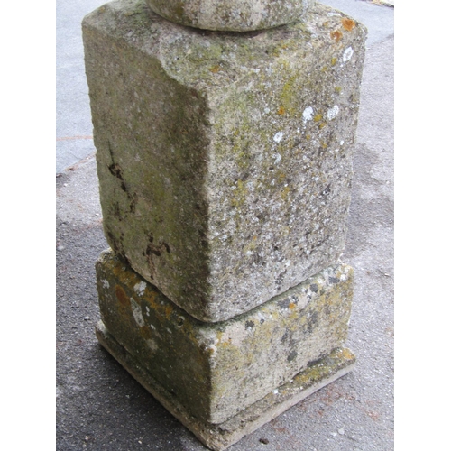 2086 - A weathered natural stone garden urn, the shallow circular carved bowl raised on a loose socle and s... 