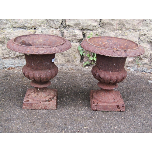 2090 - A pair of small vintage weathered cast iron campana shaped urns with flared egg and dart rims, 23cm ... 