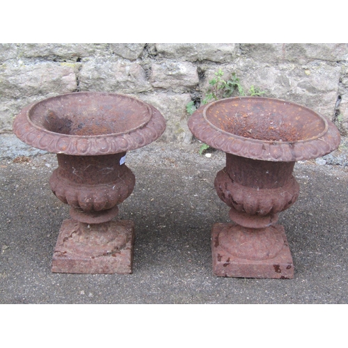 2090 - A pair of small vintage weathered cast iron campana shaped urns with flared egg and dart rims, 23cm ... 