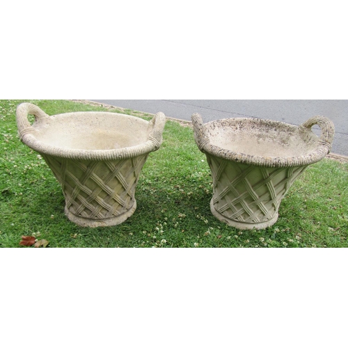 2093 - A pair of weathered cast composition stone garden planters in the form of wicker baskets with loop h... 